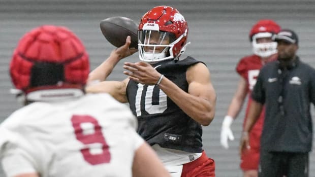 Razorbacks' quarterback Taylen Green throwing a pass in Friday practice
